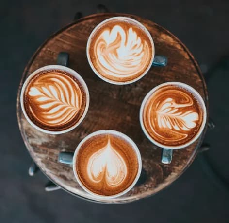 Four cappuccinos showing the classic foam layer